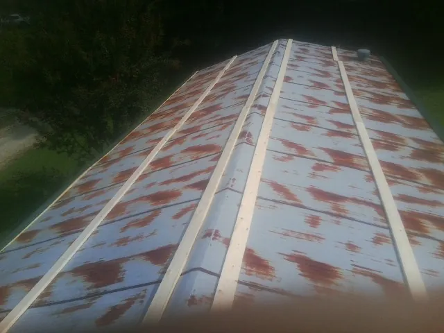 Rusted metal roof panels with new wood purlins before replacement — Storm Damage Roof Repair in Stroudsburg by Roofing Brothers